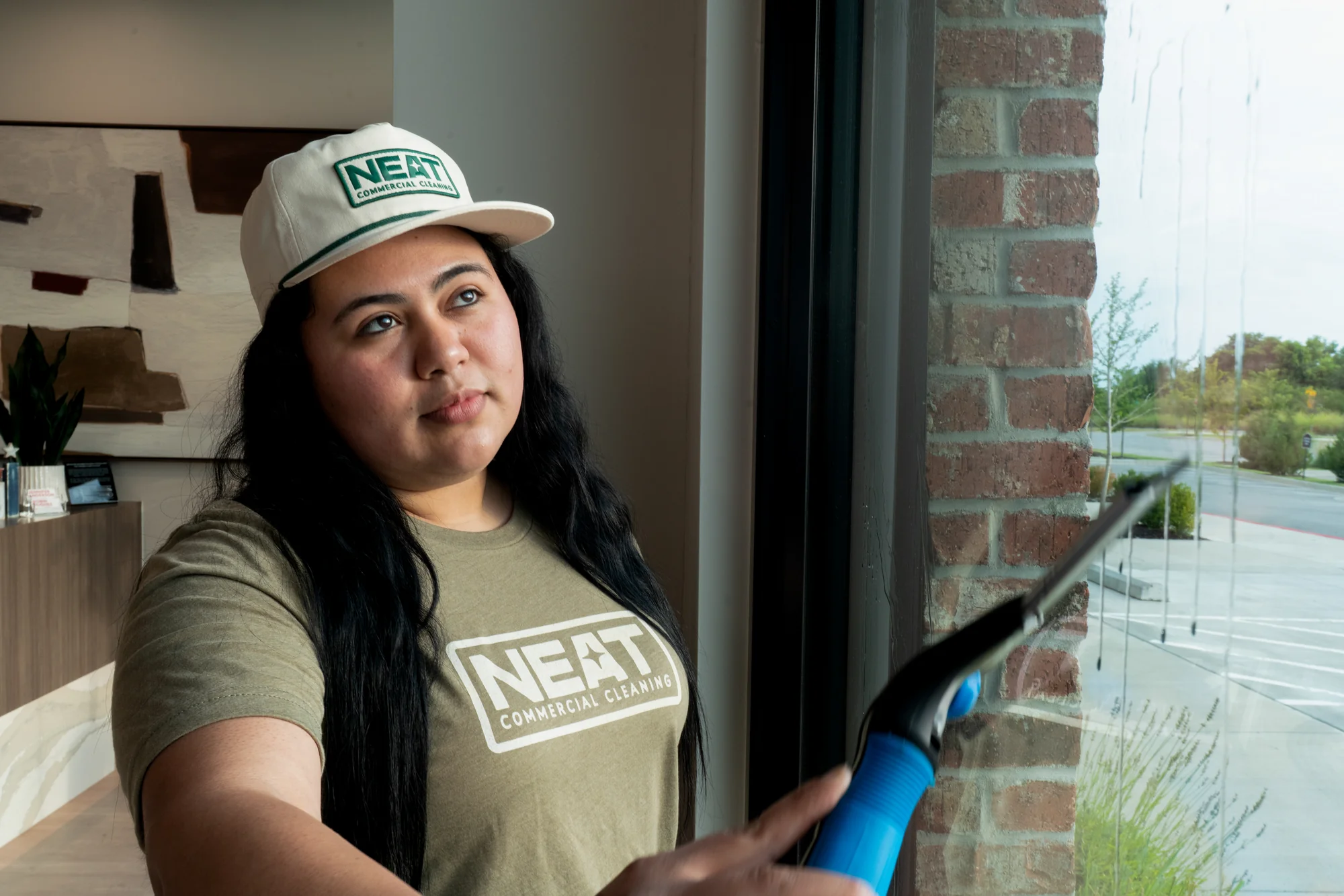 Professional commercial window cleaning with squeegee in Washington County, AR