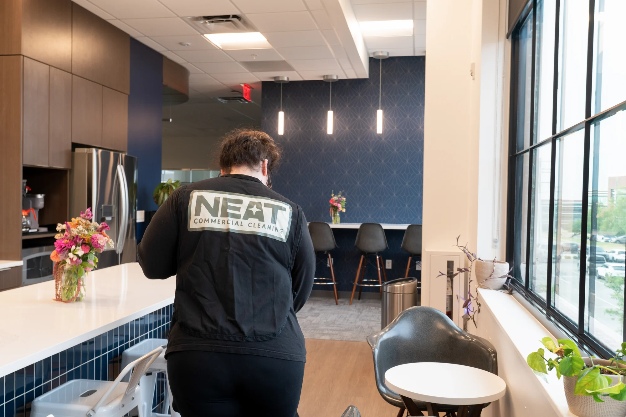 Neat day porter cleaning an office break room in Northwest Arkansas