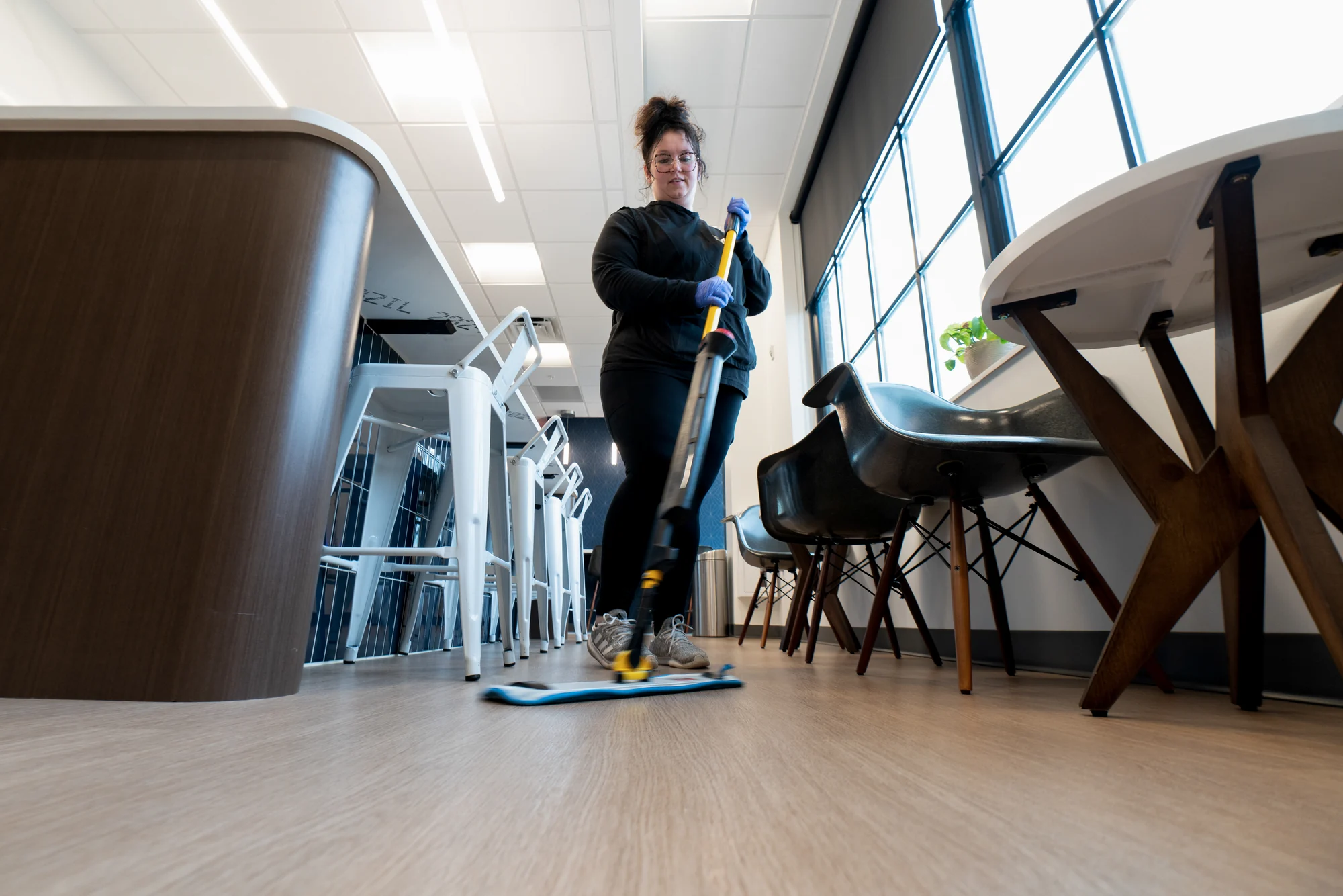 Flat mopping hard floors in a Northwest Arkansas office during janitorial service. Janitorial Service near me