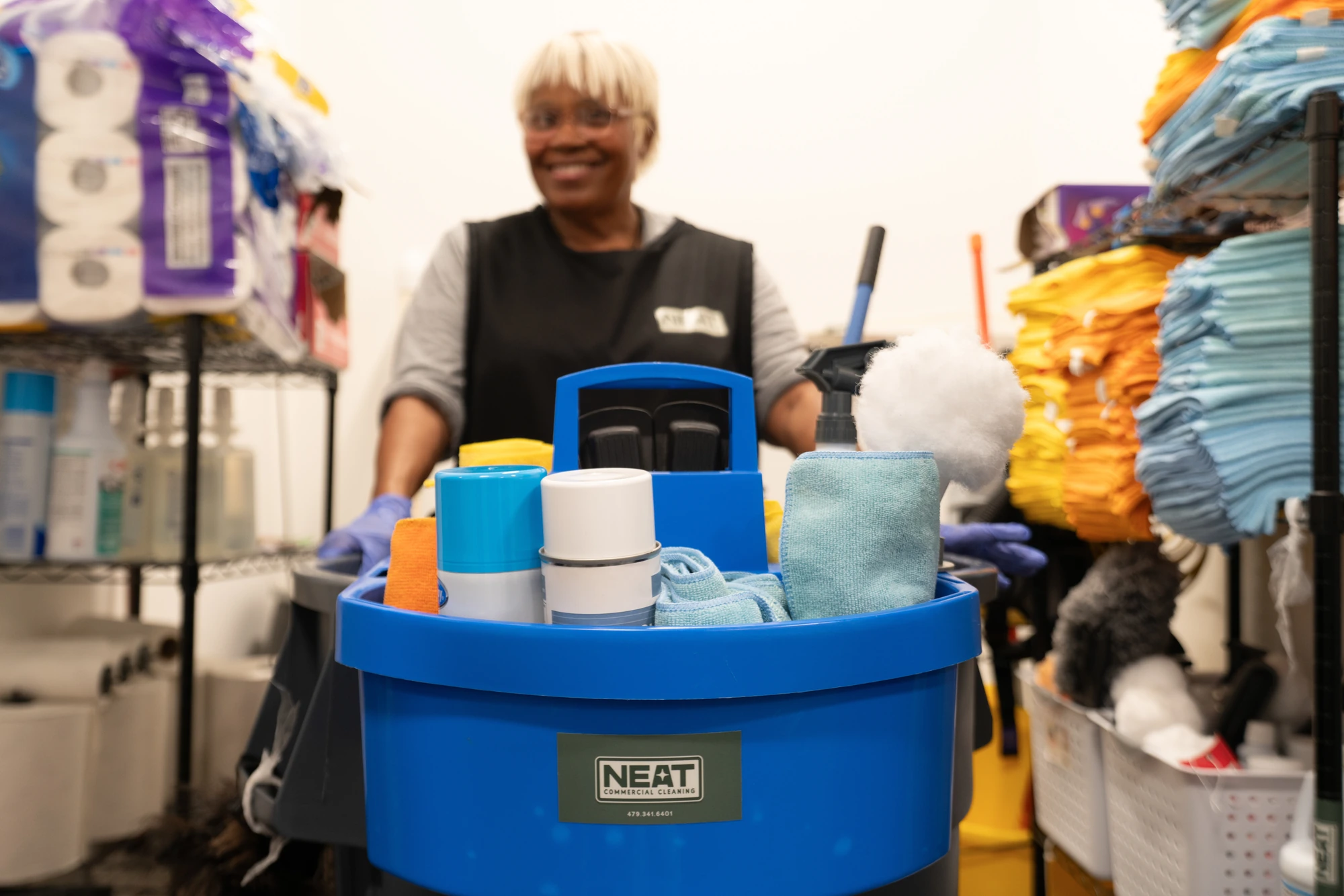 Neat Commercial Cleaning team member with stocked janitorial supply cart in Rogers, AR