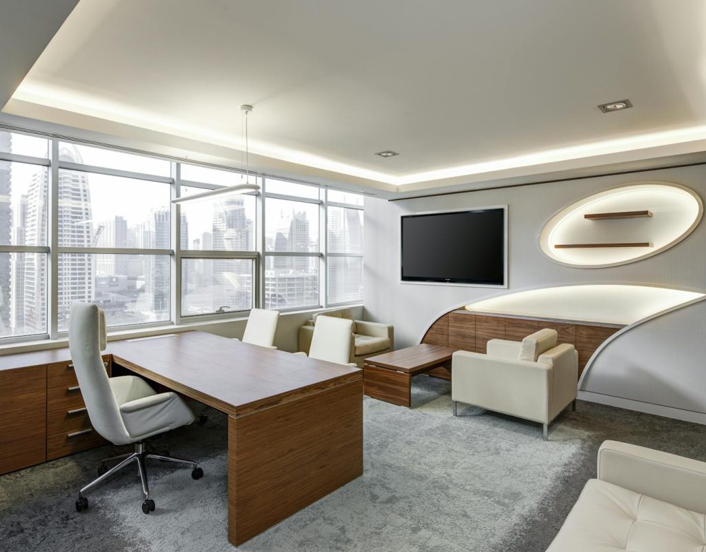 Sleek office space featuring contemporary furniture and city skyline views, ideal for professionals.