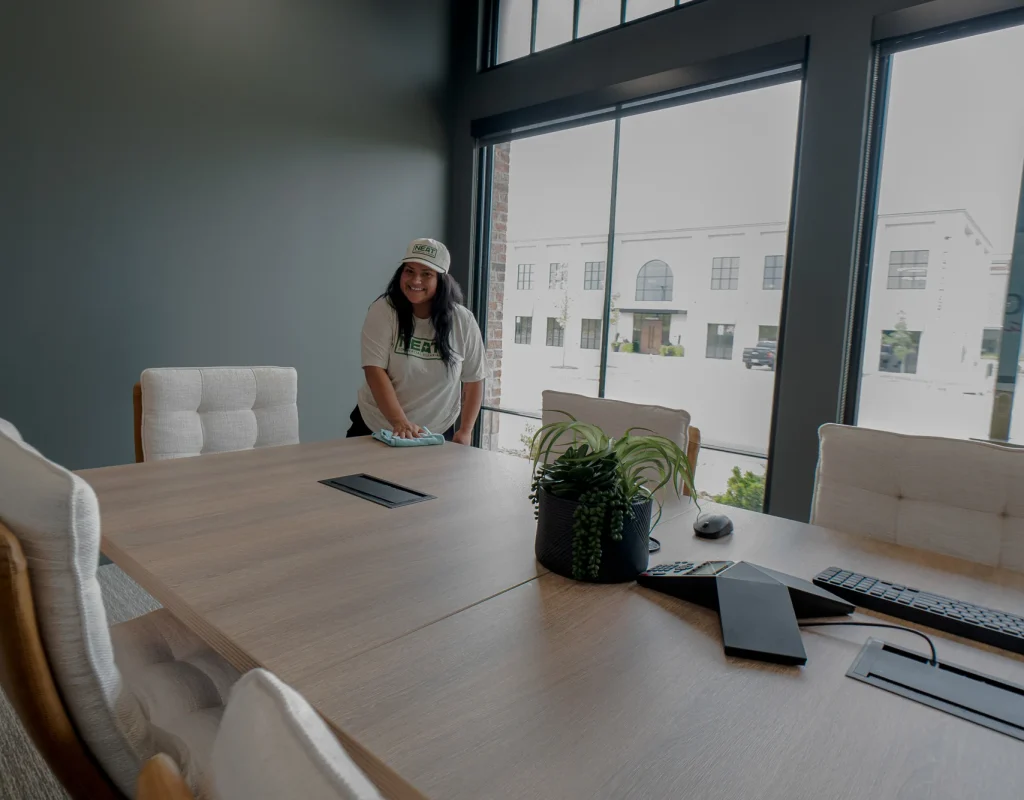 Neat team member cleaning a conference room in Rogers, AR