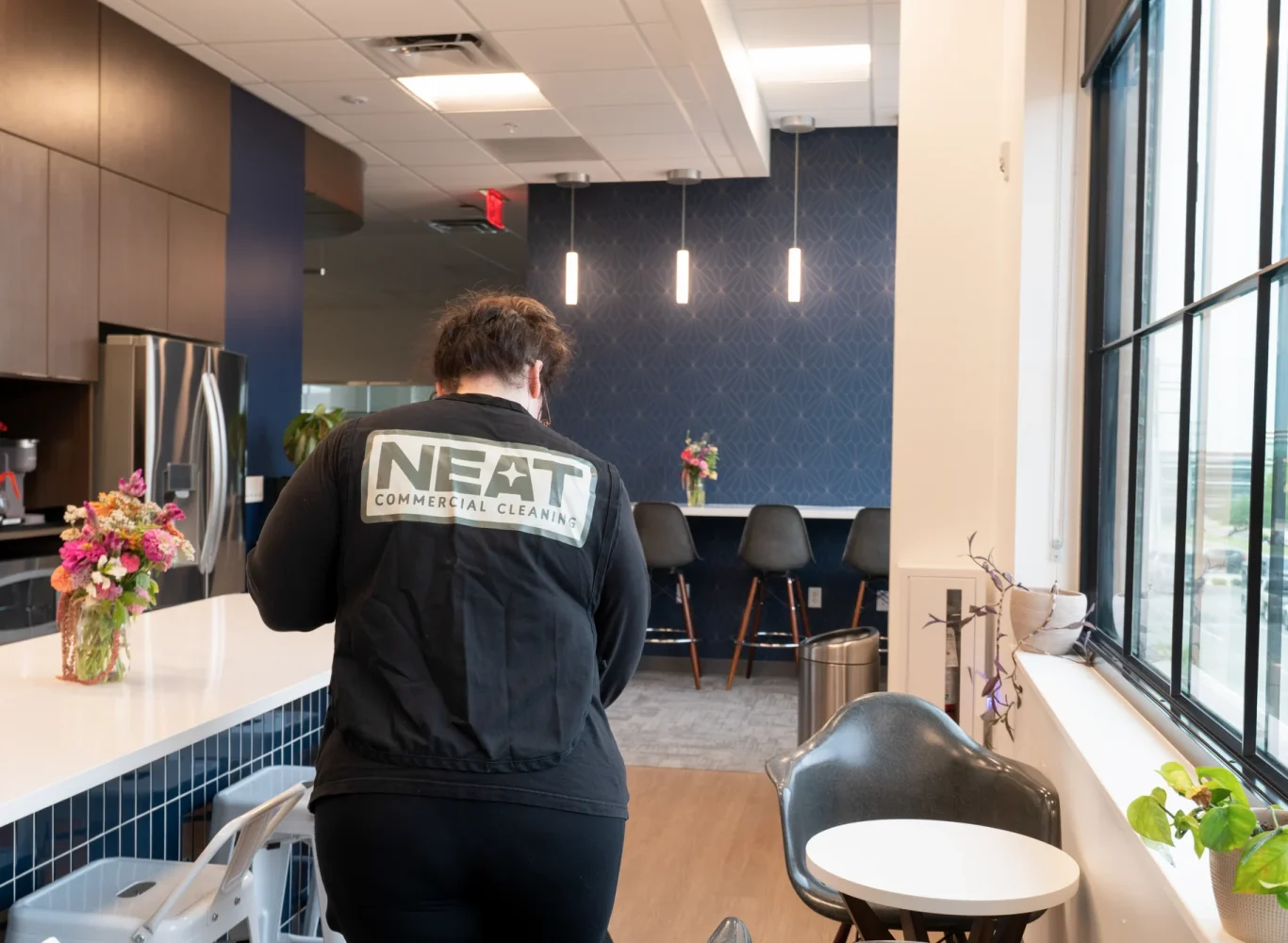 Neat day porter cleaning an office break room in Northwest Arkansas