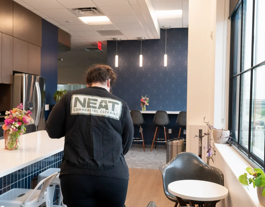 Neat day porter cleaning an office break room in Northwest Arkansas
