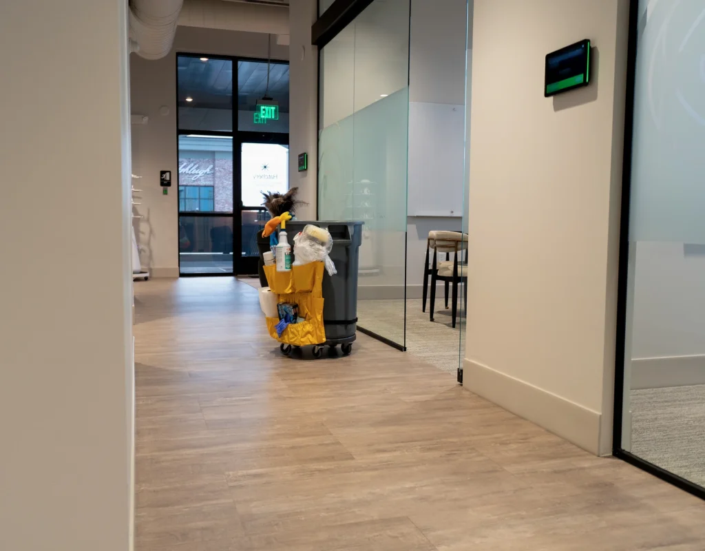 Janitorial cart in an office hallway during day porter service in Northwest Arkansas