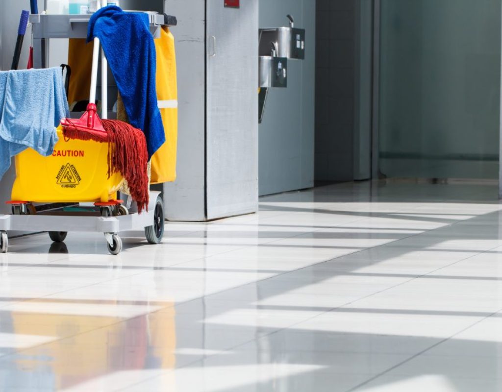 Professional day porter removing trash and maintaining cleanliness in commercial facility