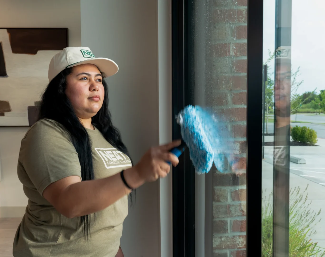 Team member cleaning interior office windows with microfiber cloth in Washington County, AR