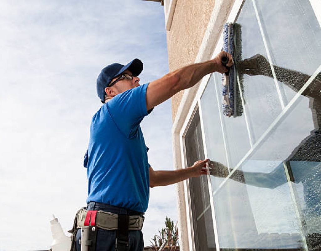 Cleaning crew maintaining clear glass surfaces in corporate office space