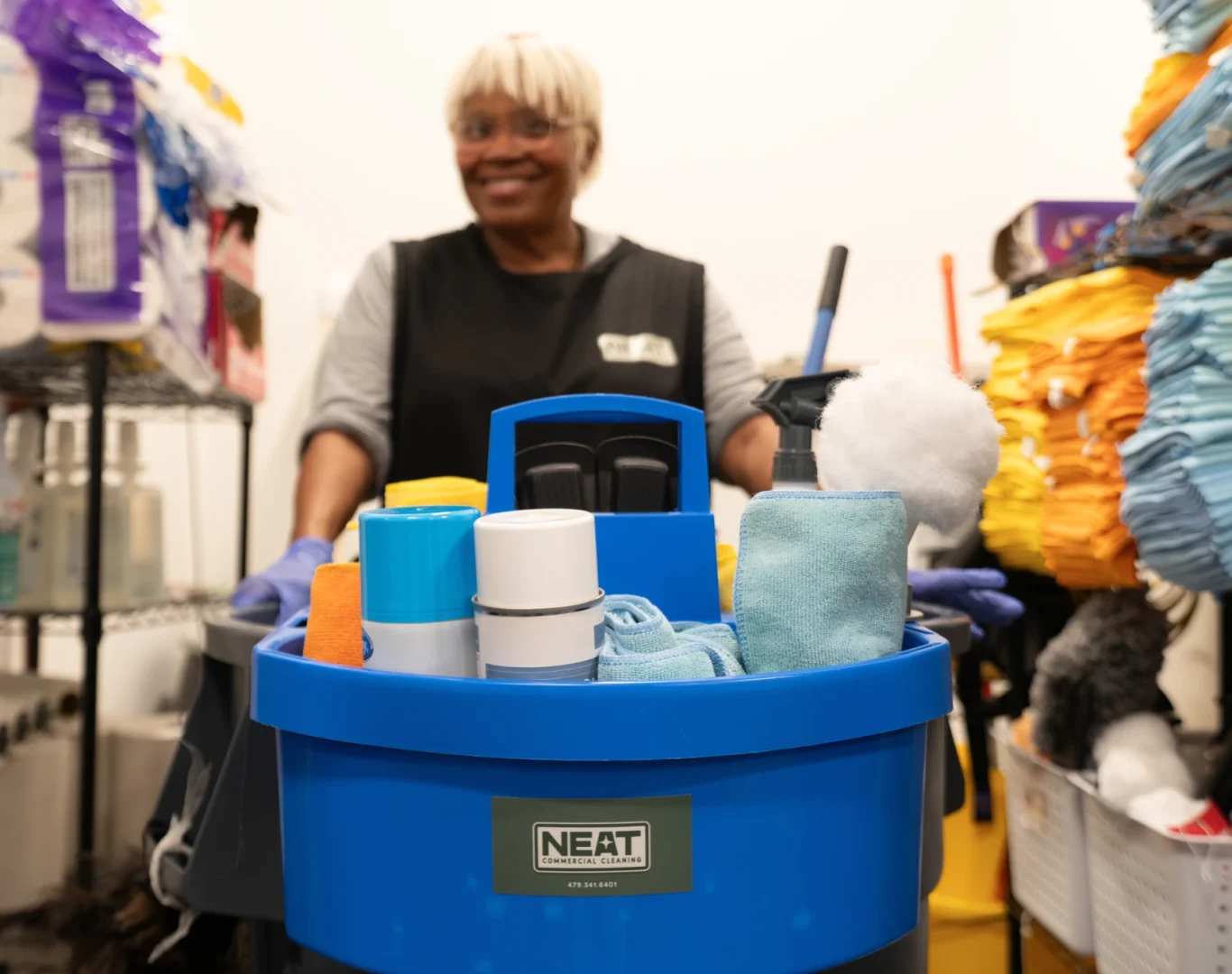 Neat Commercial Cleaning team member with stocked janitorial supply cart in Rogers, AR