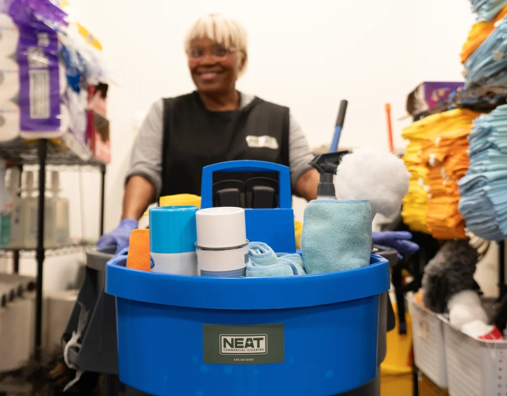 Neat Commercial Cleaning team member with stocked janitorial supply cart in Rogers, AR