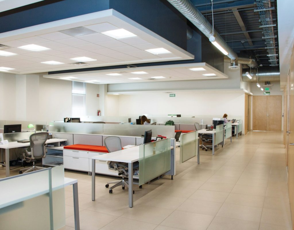 Professional cleaning crew sanitizing office desks in Lowell AR